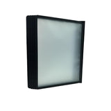 Black frame with a clear glass panel on a white surface, with a store shelf in the background.